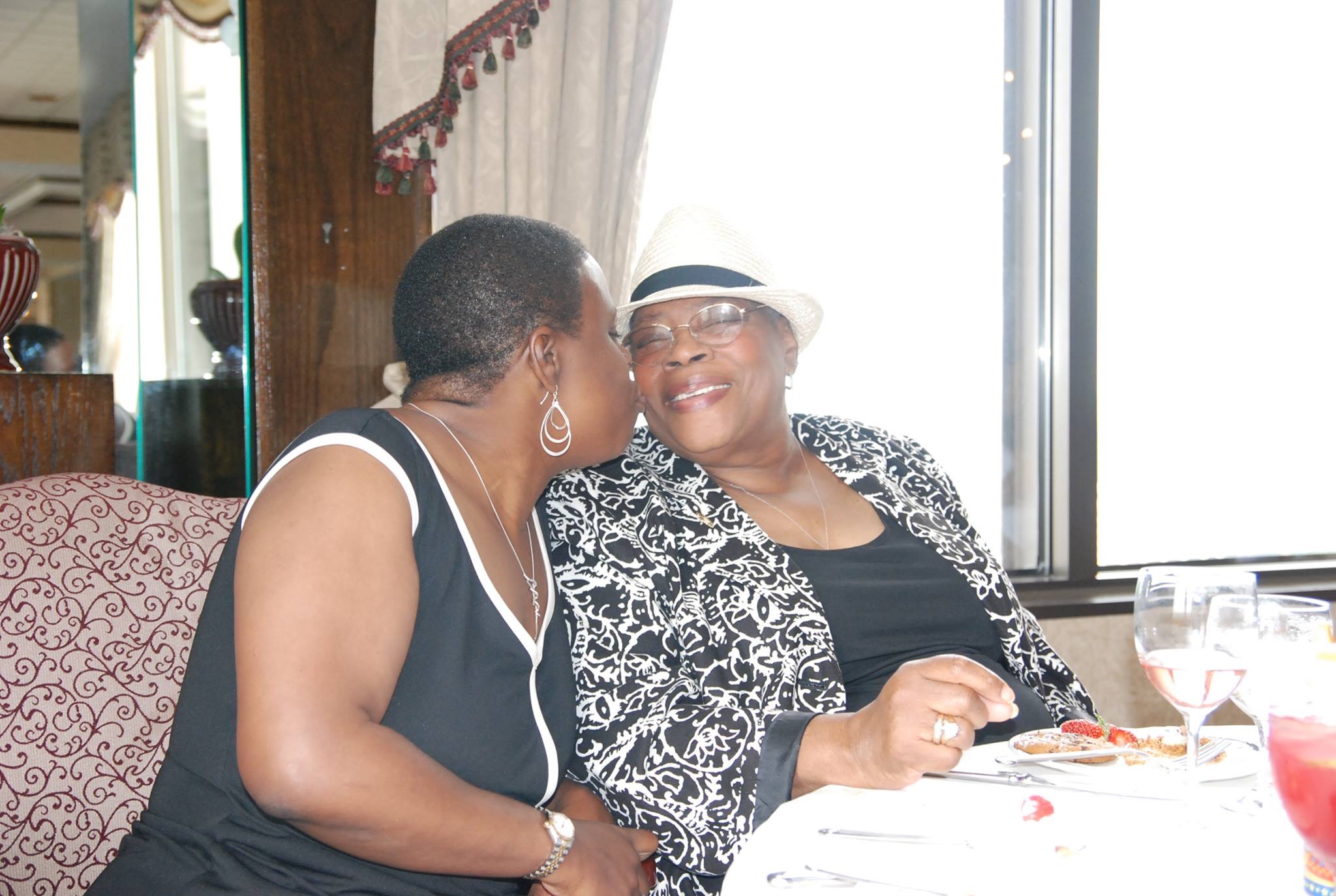 Catherine and Louise sharing a moment at dinner