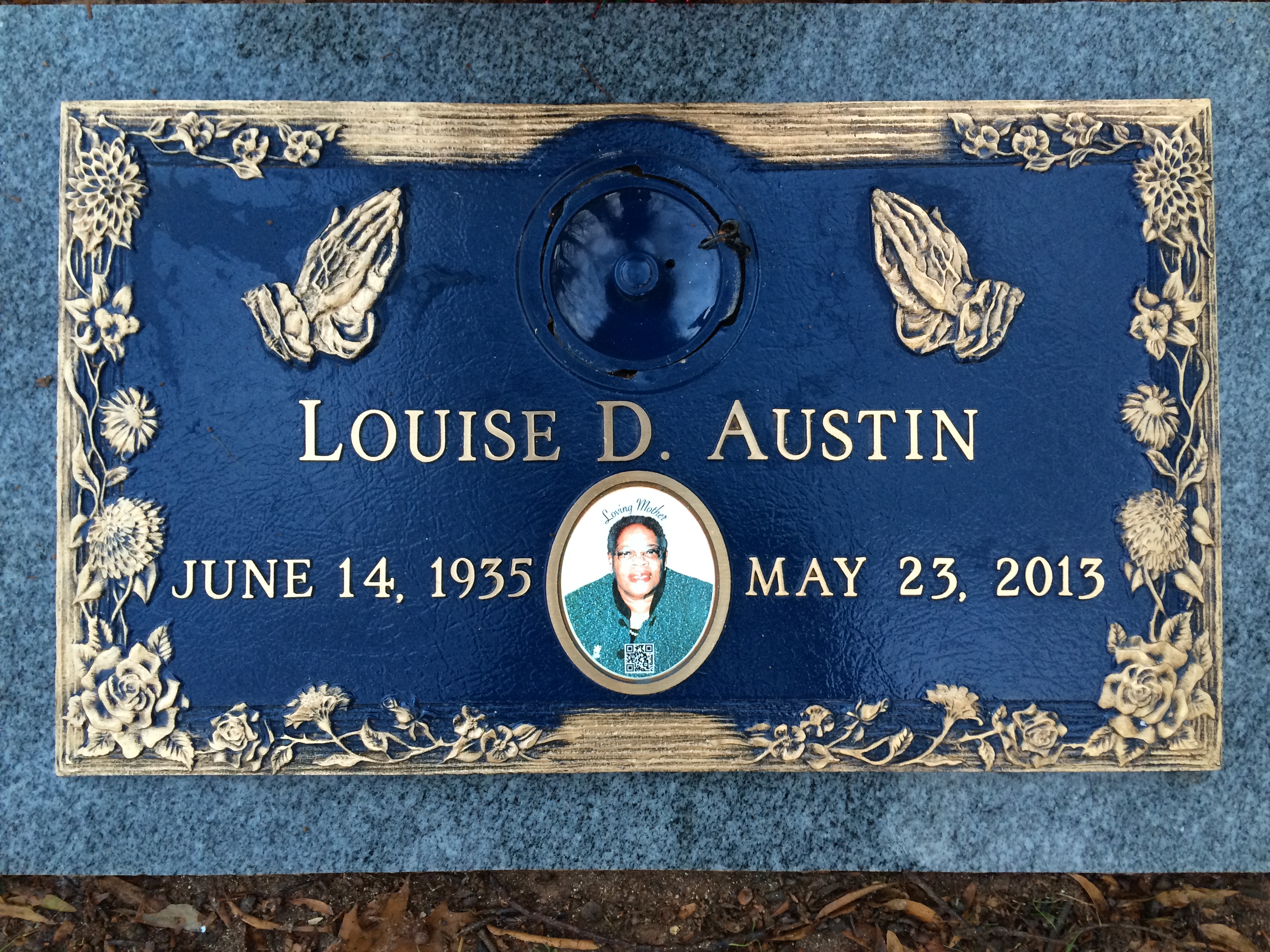 Louise D. Austin - headstone with praying hands and floral border